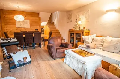 a living room with a couch and a piano at Chalet Vorgeats 2 - 6 pers - Au pied de la Flégère - Golf - UTMB in Chamonix-Mont-Blanc