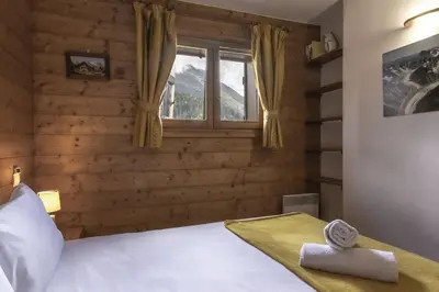 a bedroom with a bed and a window at Appartement Bellevue Au pied des pistes in Les Houches