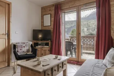 a living room with a view of a mountain at Appartement Bellevue Au pied des pistes in Les Houches