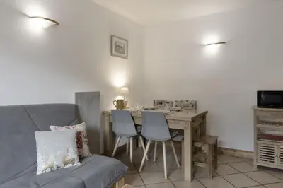 a living room with a table and a couch at Appartement Bellevue Au pied des pistes in Les Houches