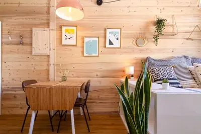 a dining room with wooden walls and a table and chairs at Chailloud - Modern Studio 2pax - Lively Area - TV Wifi in Chamonix-Mont-Blanc