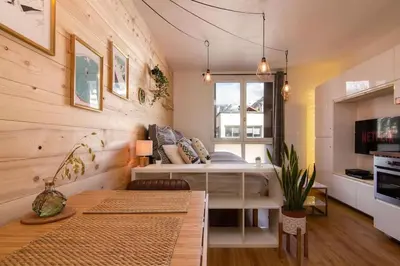 a small bedroom with a bed and a window at Chailloud - Modern Studio 2pax - Lively Area - TV Wifi in Chamonix-Mont-Blanc