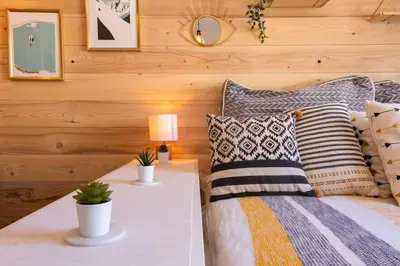 a bedroom with a bed with pillows and a table at Chailloud - Modern Studio 2pax - Lively Area - TV Wifi in Chamonix-Mont-Blanc