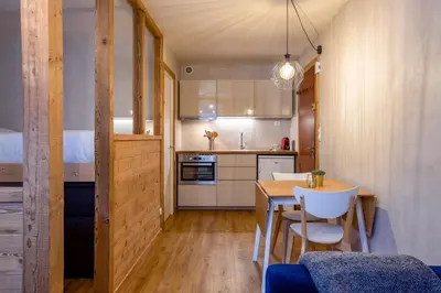 a kitchen and dining room with a table and chairs at Le Cry - Cosy studio 2pax - Free Parking - 5mn City Center in Chamonix-Mont-Blanc