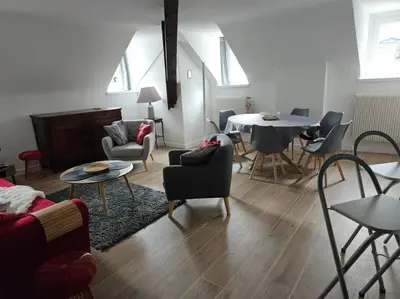 a living room with a table and chairs at Appartement hyper centre, idéal pour 4 pers possibilité 6 couchages in Chamonix-Mont-Blanc