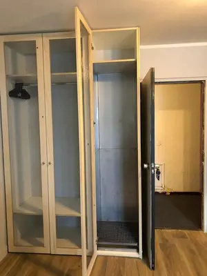 a glass closet with a glass door in a room at Base Camp Chamonix Vue Mont Blanc Centre Ville in Chamonix-Mont-Blanc
