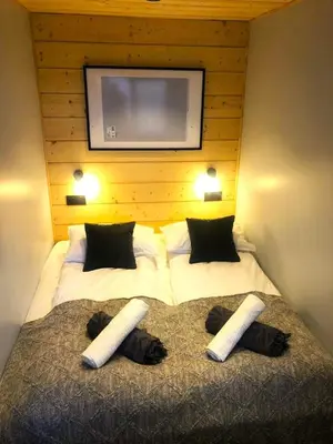 a bedroom with a large bed with a flat screen tv at Base Camp Chamonix Vue Mont Blanc Centre Ville in Chamonix-Mont-Blanc