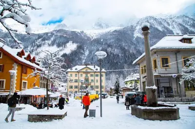a street in a town with people walking in the snow at Base Camp Chamonix Vue Mont Blanc Centre Ville in Chamonix-Mont-Blanc