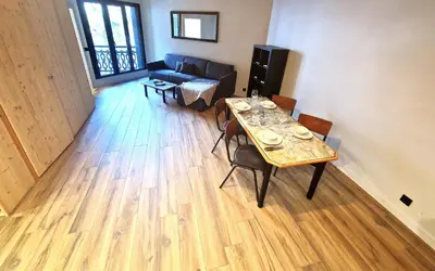 a living room with a table and a couch at Base Camp Chamonix Vue Mont Blanc Centre Ville in Chamonix-Mont-Blanc