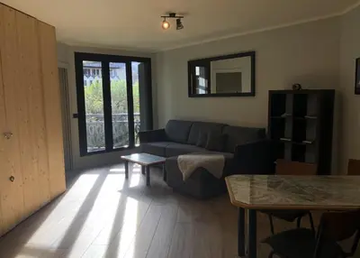 a living room with a couch and a table at Base Camp Chamonix Vue Mont Blanc Centre Ville in Chamonix-Mont-Blanc