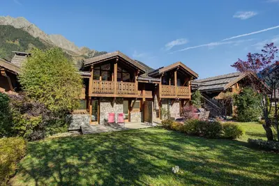 a log home with a large yard in front at Chalet d'Olivier - Alpes Travel - Les Praz (Sleeps 8) in Chamonix-Mont-Blanc