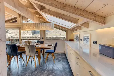 a dining room with a table and chairs in a kitchen at Chalet d'Olivier - Alpes Travel - Les Praz (Sleeps 8) in Chamonix-Mont-Blanc