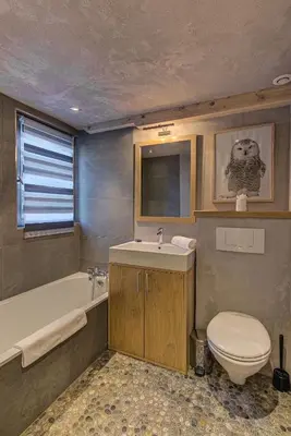a bathroom with a toilet and a tub and a sink at Chalet d'Olivier - Alpes Travel - Les Praz (Sleeps 8) in Chamonix-Mont-Blanc