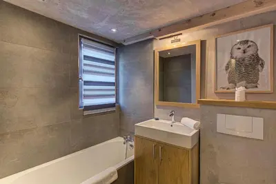 a bathroom with a sink and a bath tub at Chalet d'Olivier - Alpes Travel - Les Praz (Sleeps 8) in Chamonix-Mont-Blanc