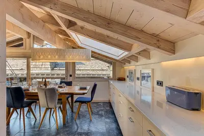 a dining room with a table and chairs at Chalet d'Olivier - Alpes Travel - Les Praz (Sleeps 8) in Chamonix-Mont-Blanc