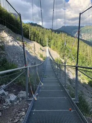 a suspension bridge on the side of a mountain at Appartement au pays du Mont-Blanc in Sallanches