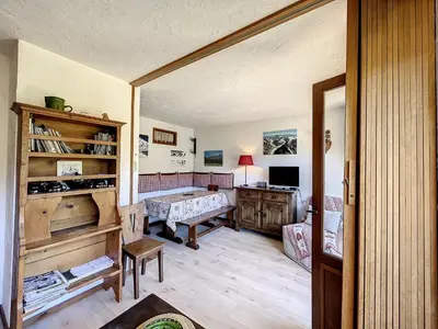 a living room with a table and a desk at Studio Cabine pour 4 Pers à Deux Pas du Domaine Evasion Megève - FR-1-560-104 in Demi-Quartier