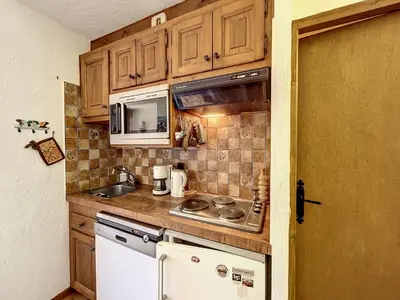 a small kitchen with a sink and a stove at Studio Cabine pour 4 Pers à Deux Pas du Domaine Evasion Megève - FR-1-560-104 in Demi-Quartier