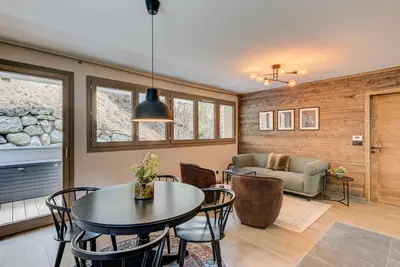 a living room with a table and chairs and a couch at White Pearl A02 - Alpes Travel - Chamonix - Sleeps 4 in Chamonix-Mont-Blanc