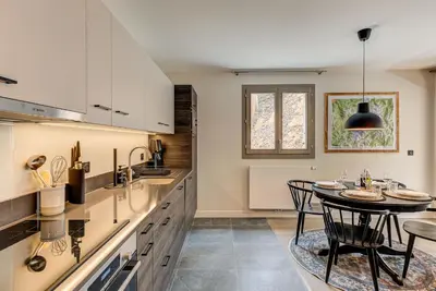a kitchen with a table and a dining room at White Pearl A02 - Alpes Travel - Chamonix - Sleeps 4 in Chamonix-Mont-Blanc