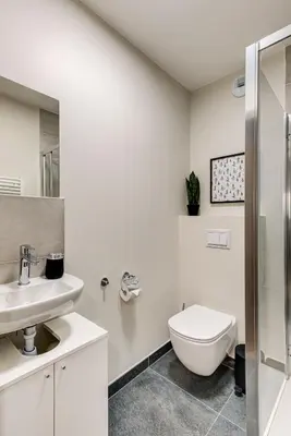 a white bathroom with a toilet and a sink at White Pearl A02 - Alpes Travel - Chamonix - Sleeps 4 in Chamonix-Mont-Blanc