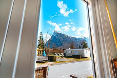 a view of a mountain from a window at Bungalow 3 chambres pour 6 pers avec Climatisation Camping 3 etoiles in Samoëns