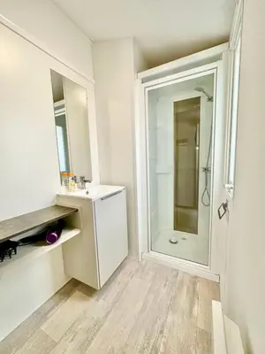 a white bathroom with a sink and a shower at Bungalow 3 chambres pour 6 pers avec Climatisation Camping 3 etoiles in Samoëns