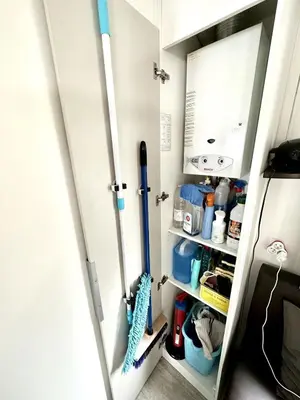 a small kitchen with a door open to a pantry at Bungalow 3 chambres pour 6 pers avec Climatisation Camping 3 etoiles in Samoëns