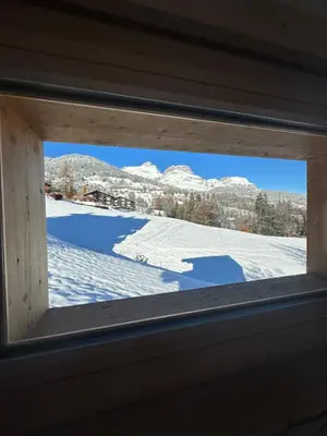a window in a room with snow on the ground at Chalet neuf La Perle du Perron in Cordon