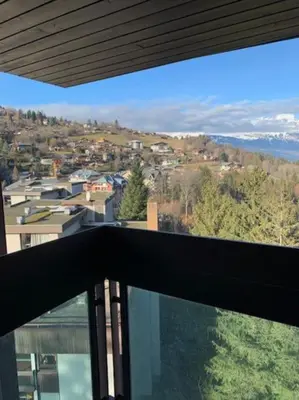 a view of a city from a balcony of a house at Duplex St Gervais rooftop - 500m des télécabines in Saint-Gervais-les-Bains