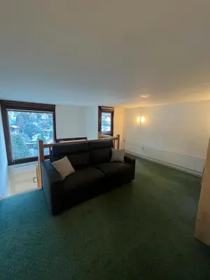 a living room with a couch and a large window at Duplex St Gervais rooftop - 500m des télécabines in Saint-Gervais-les-Bains