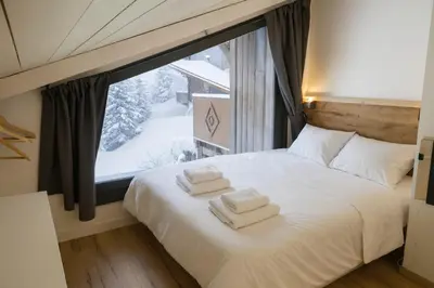 a living room with a couch and a table at Bright apt facing the Mont Blanc chain in Les Houches