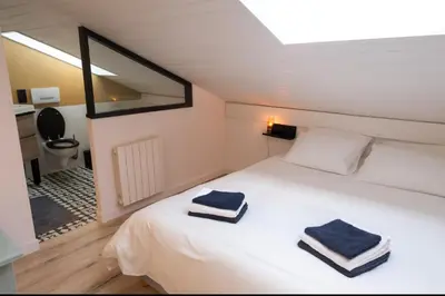 a bedroom with a bed with two towels on it at Bright apt facing the Mont Blanc chain in Les Houches