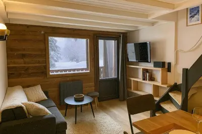 a bedroom with a bed with two towels on it at Bright apt facing the Mont Blanc chain in Les Houches