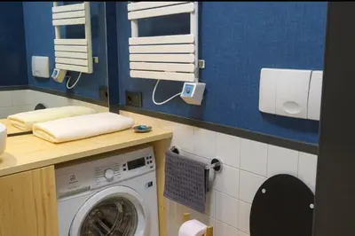 a laundry room with a washer and dryer at Bright apt facing the Mont Blanc chain in Les Houches