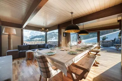 a dining room with a long table with chairs at L'ivresse du Mont-Blanc in Saint-Gervais-les-Bains