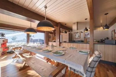 a bedroom with a bed and a large window with mountains at L'ivresse du Mont-Blanc in Saint-Gervais-les-Bains