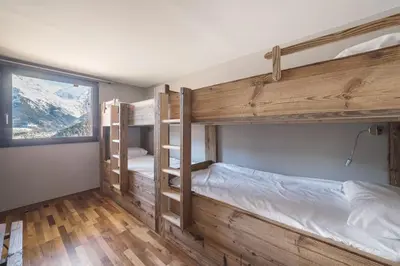 a bedroom with a bed and a large window at L'ivresse du Mont-Blanc in Saint-Gervais-les-Bains