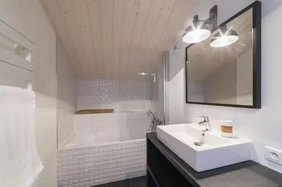 a bathroom with two sinks and a mirror at L'ivresse du Mont-Blanc in Saint-Gervais-les-Bains