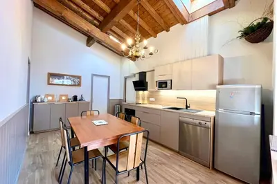 a kitchen with a table and chairs and a refrigerator at Évasion au Sommet in Combloux