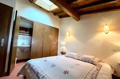 a bedroom with a bed and a sink in it at Évasion au Sommet in Combloux